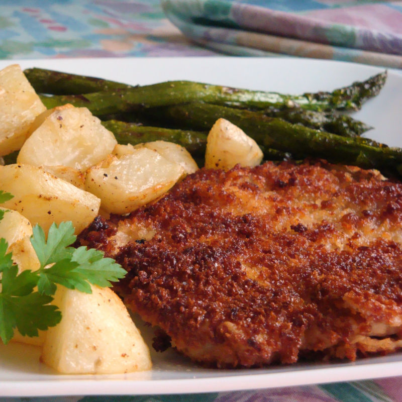 Oma's pork schnitzel served with asparagus and potatoes