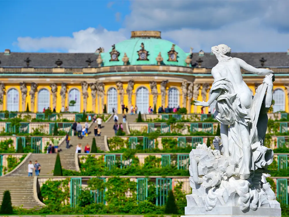 Statue in front of the grand staircase and terraces of Sanssouci Palace in Potsdam, Germany.