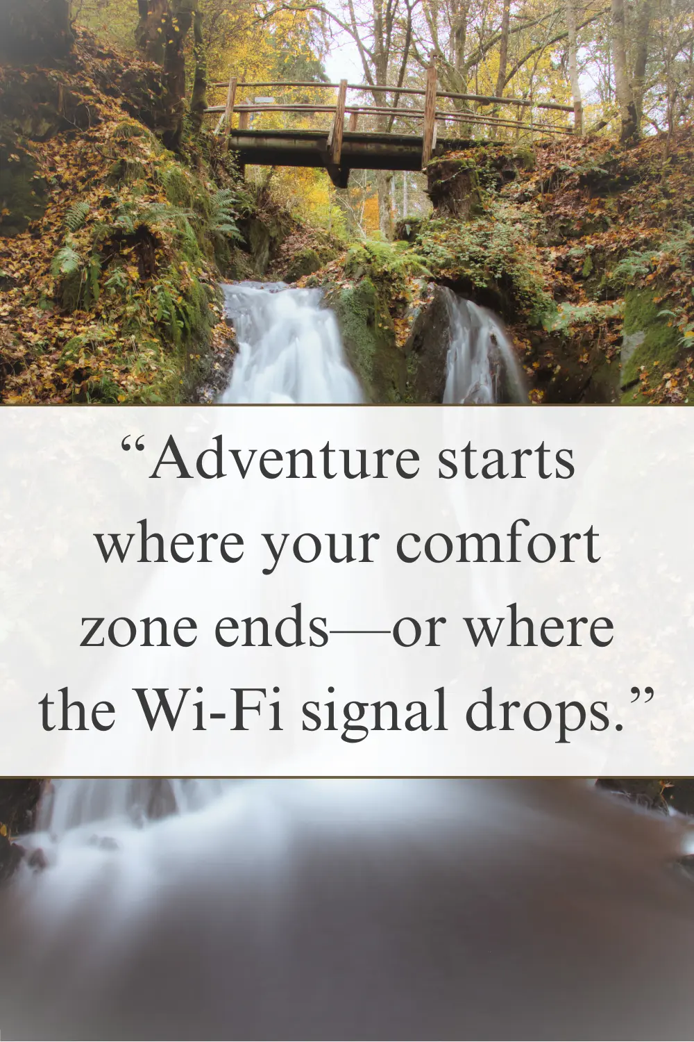 A cascading waterfall in a lush forest with a wooden bridge above