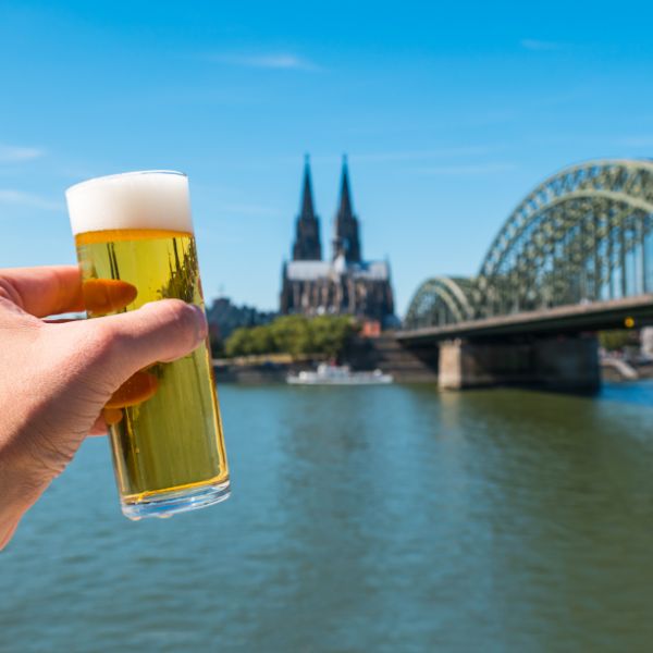 Koelsch beer in front of Cologne skyscape