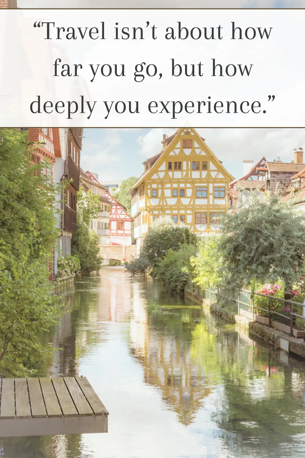 A serene canal lined with colorful half-timbered houses, reflecting in the water