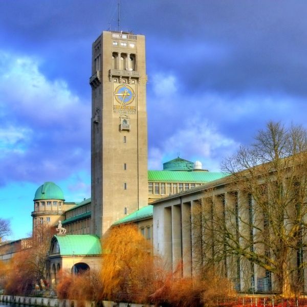 Clocktower at Deutsches Museum Grey building with clock tower and green rooftops