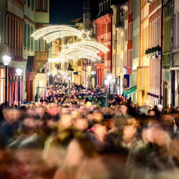 Crowds of people at night shopping on the Heidelberg Main Street