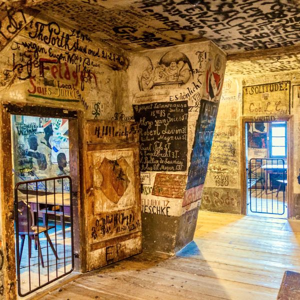 Graffiti walls and gated doorways inside Heidelberg Student Prison