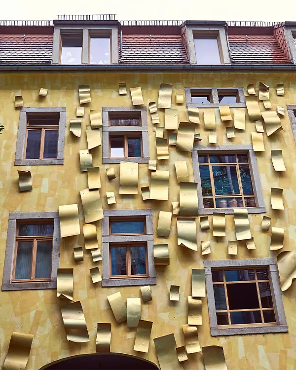 Kunsthofpassage Yellow façade with golden metal panels at Kunsthofpassage art courtyards in Dresden