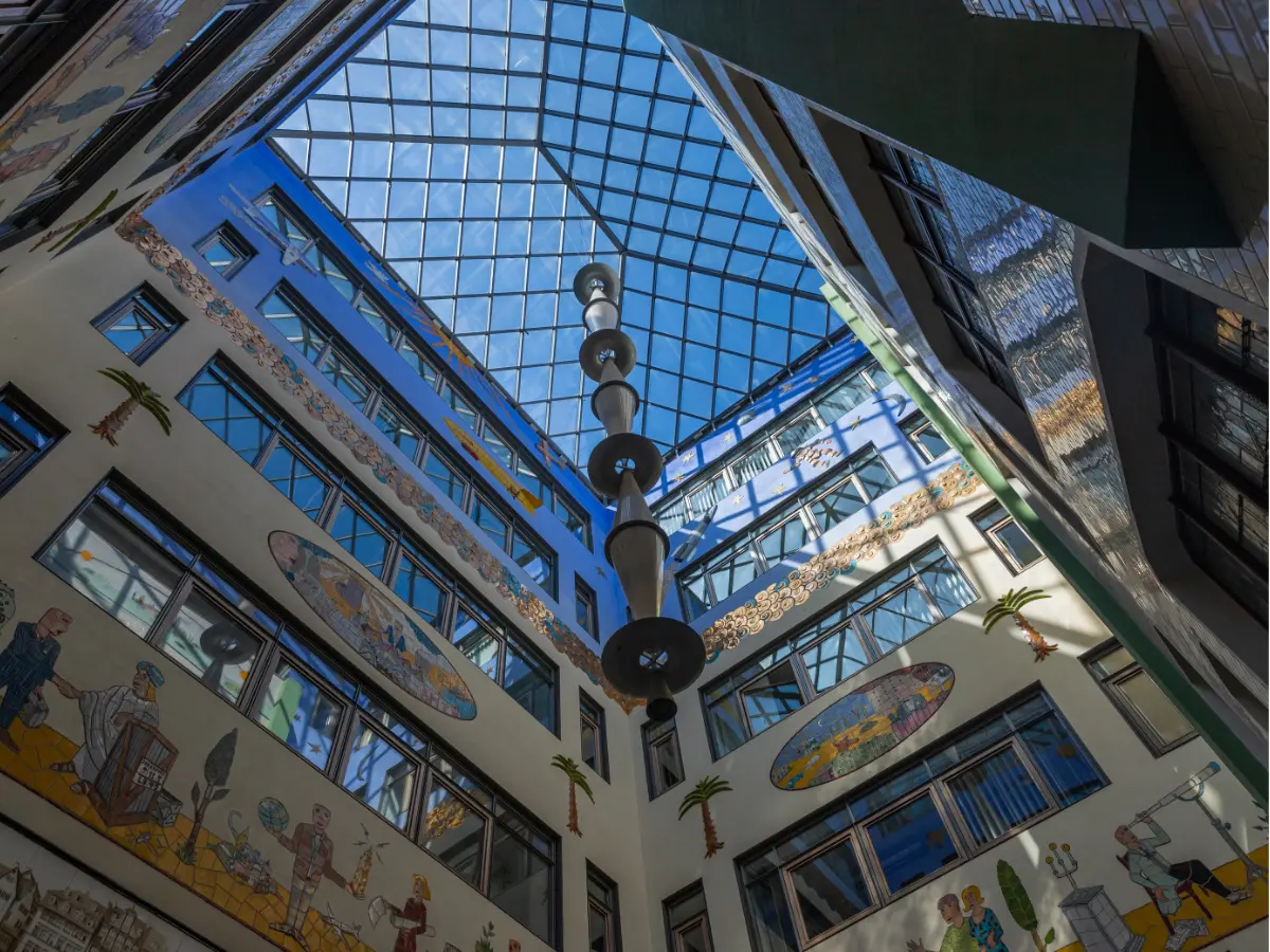 Ornate glass roof over painted walls of courtyard in Leipzig