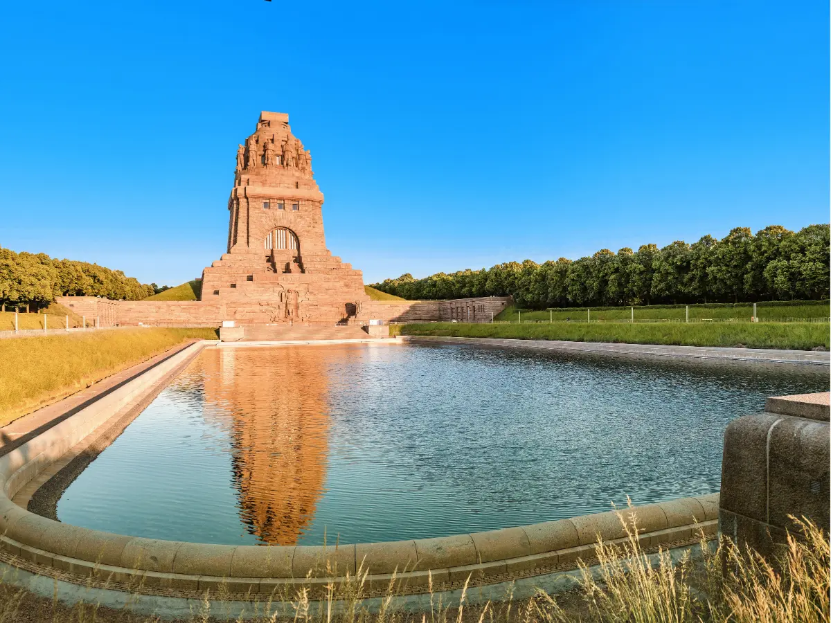 Red brick monument behind pond in Leipzig