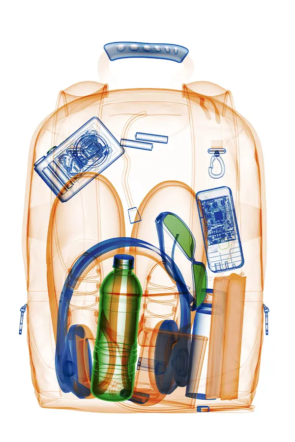 X-ray view of a backpack showing various items: headphones, a water bottle, sunglasses, a phone, a camera, and books.