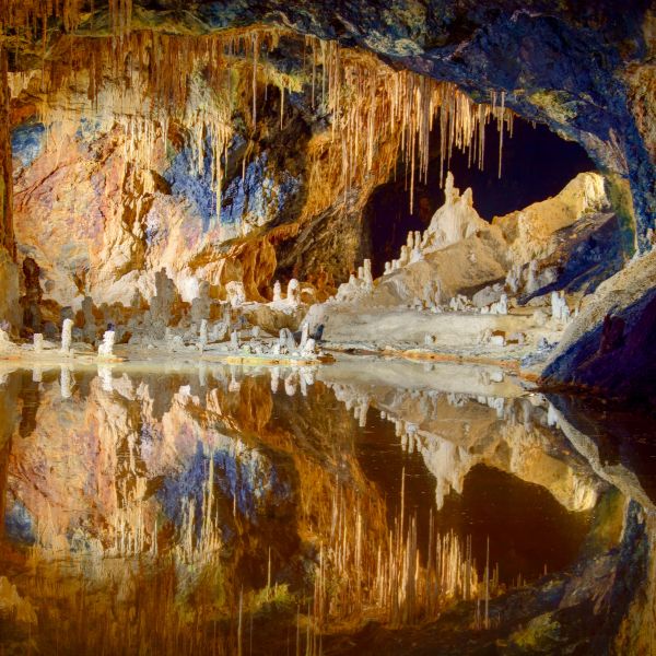 Underground lake with colourful rock formations Underground lake with colourful rock formations