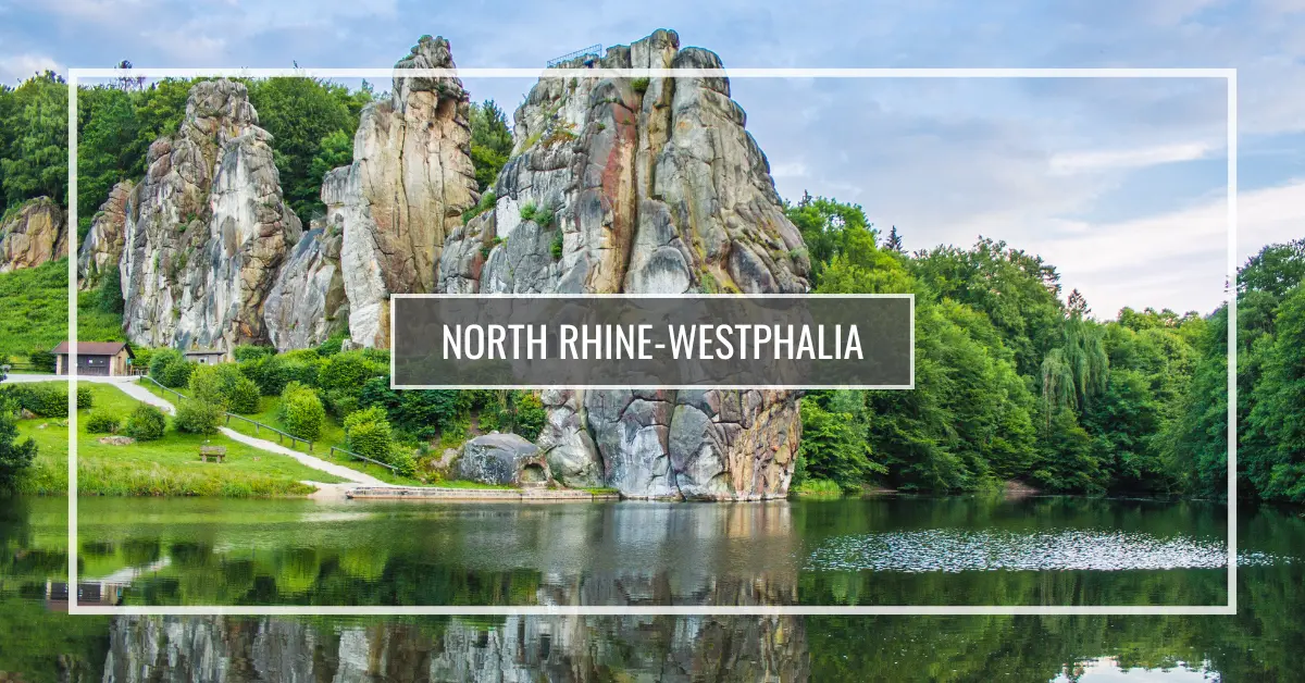 The Externsteine in Horn-Bad Meinberg Tall rocky formations surrounded by greenery and a calm lake with reflections in North Rhine-Westphalia, Germany