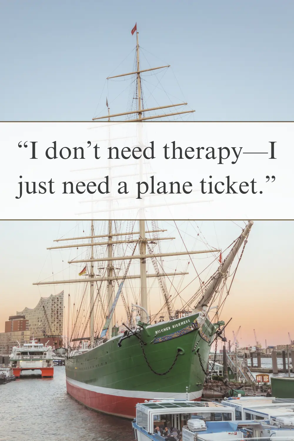 A historic sailing ship docked in a harbor at sunset