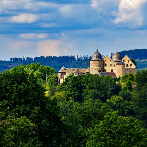 Sababurg Castle on the Fairy Tale Route castle on hill surrounded by trees