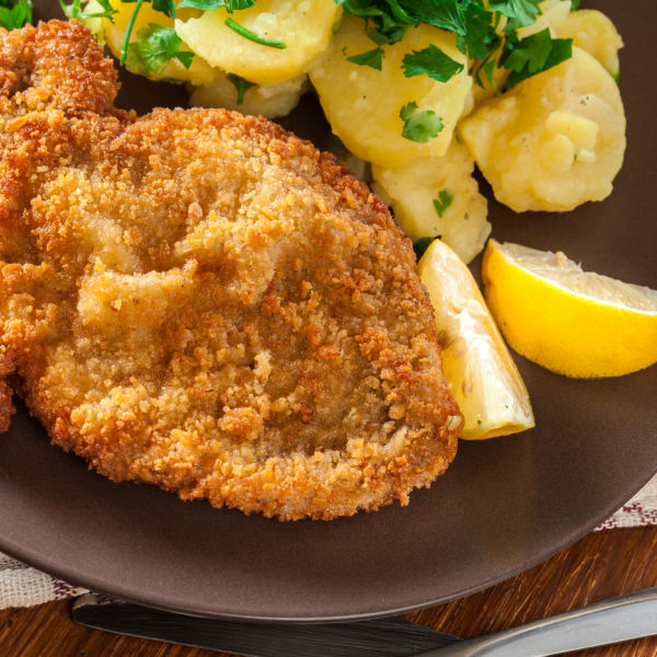 Wiener Schnitzel with lemon and boiled potatoes. Of course, made with veal!