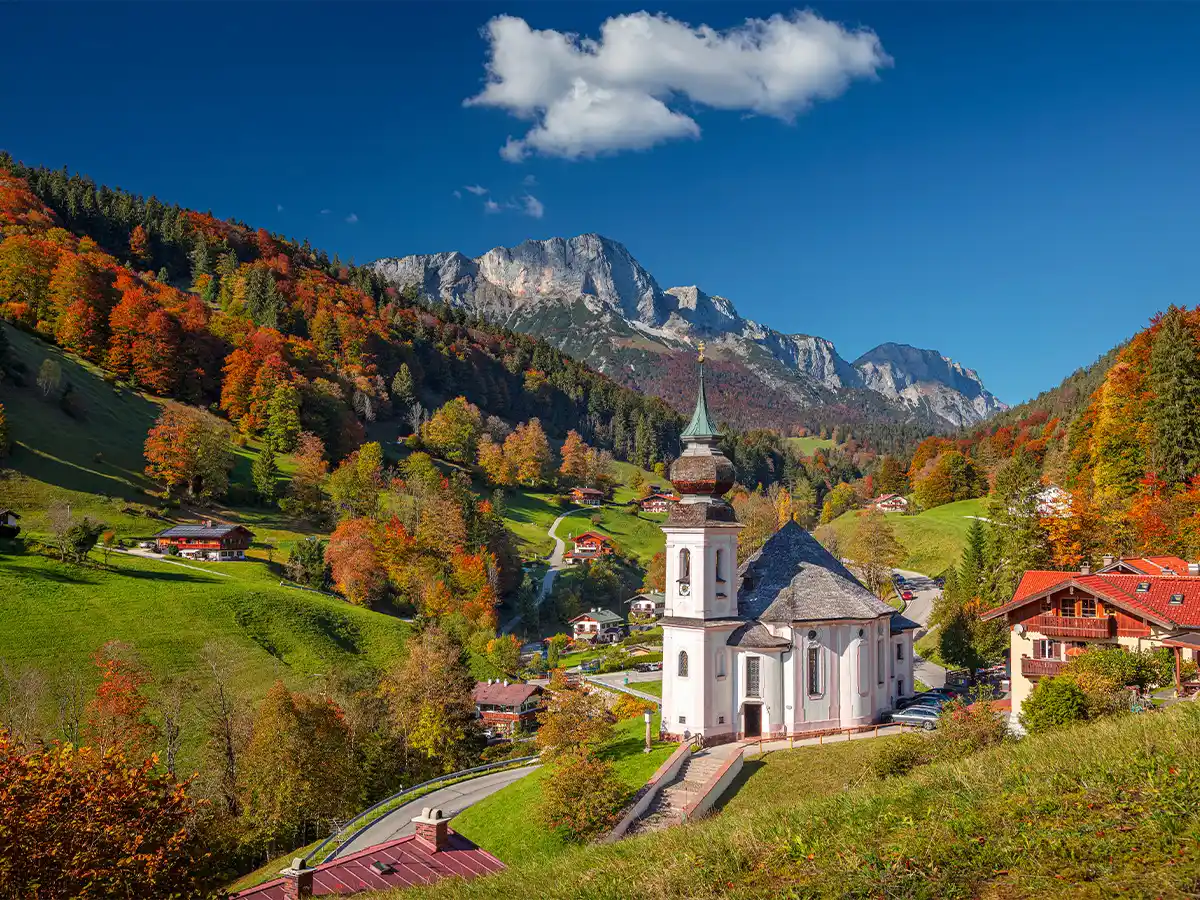 Autumn in the Bavarian Alps with colorful trees and a mountain village in October
