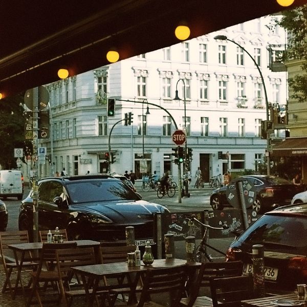 Coffee shop tables with intersection and white building 