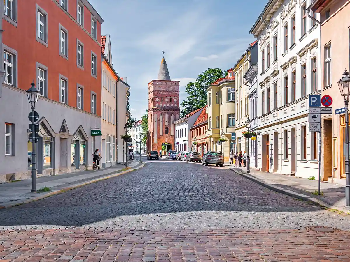 Cobbled old-town street toward medieval Rathenower Gate in Brandenburg an der Havel—things to do in Brandenburg Germany.