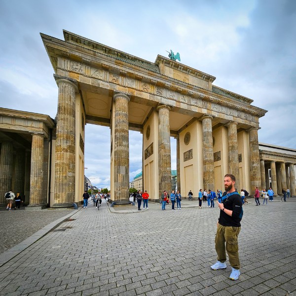 Eran standing in front of the Brandenburg Gate in Berlin