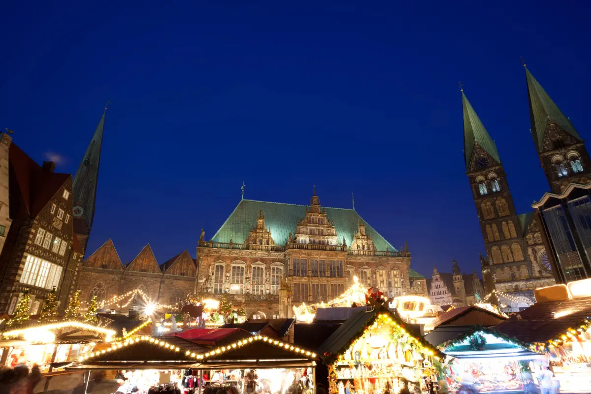 Bremen Christmas Market in the historic town square with twinkling lights and UNESCO-listed sites in the background.