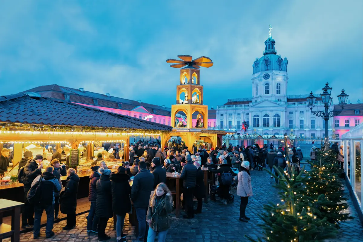 Charlottenburg Palace Christmas Market glowing with festive lights and traditional wooden stalls in Berlin.