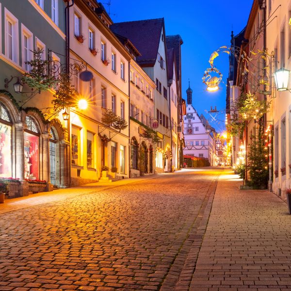 Evening view of a street in Rothenburg at Christmas, buildings lit up by lights