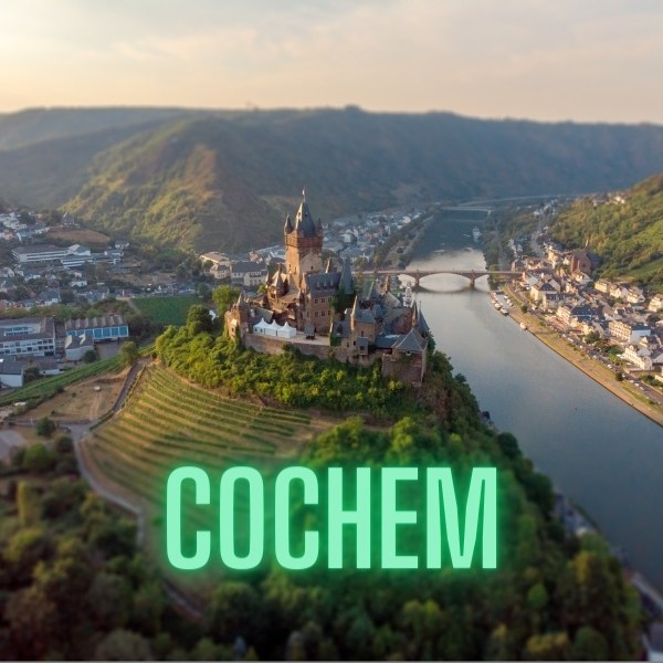 Cochem text and aerial view of castle and houses either side of river