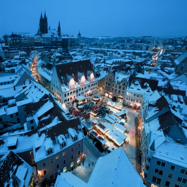 Christmas Market in small square surrounded by houses in Cologne, Germany.