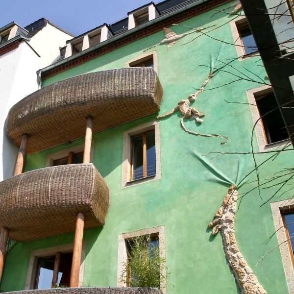 Green building with animals painted on it at the Court of Animals, Dresden