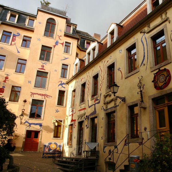 Yellow buildings with hieroglyphs at the Mystical Courtyard, Dresden
