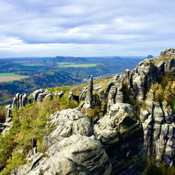 Rock outcroppings overlooking a green valley at the Swiss National Park Landscape, Dresden