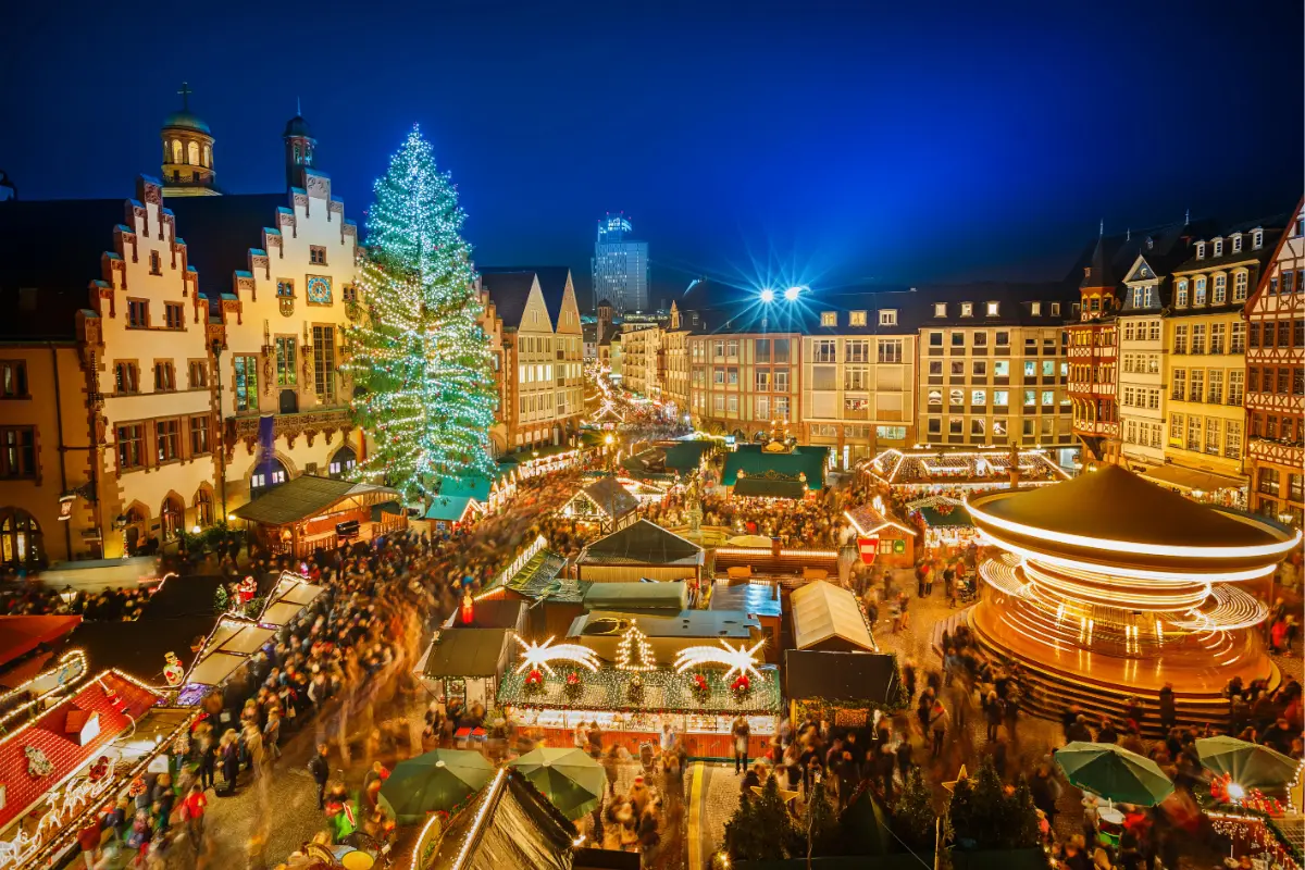 Frankfurt Christmas Market at Römerberg with a large Christmas tree and historic architecture.