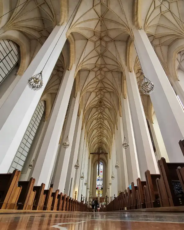 Interior of Frauenkirche in Munich, featuring vaulted ceilings and Gothic architecture.
