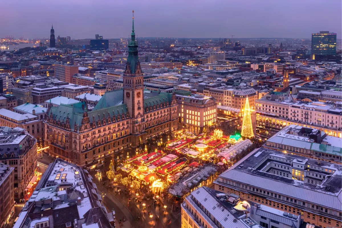 Hamburg Christmas Market with maritime-themed stalls and a historic carousel near the Town Hall.
