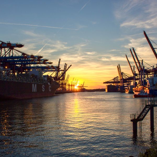 Hamburg Port at sunset with cranes and ships
