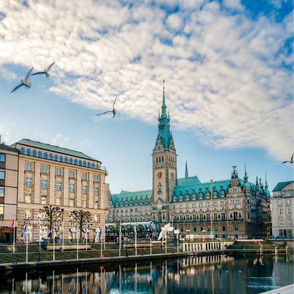 Town hall with green roof and tower along river