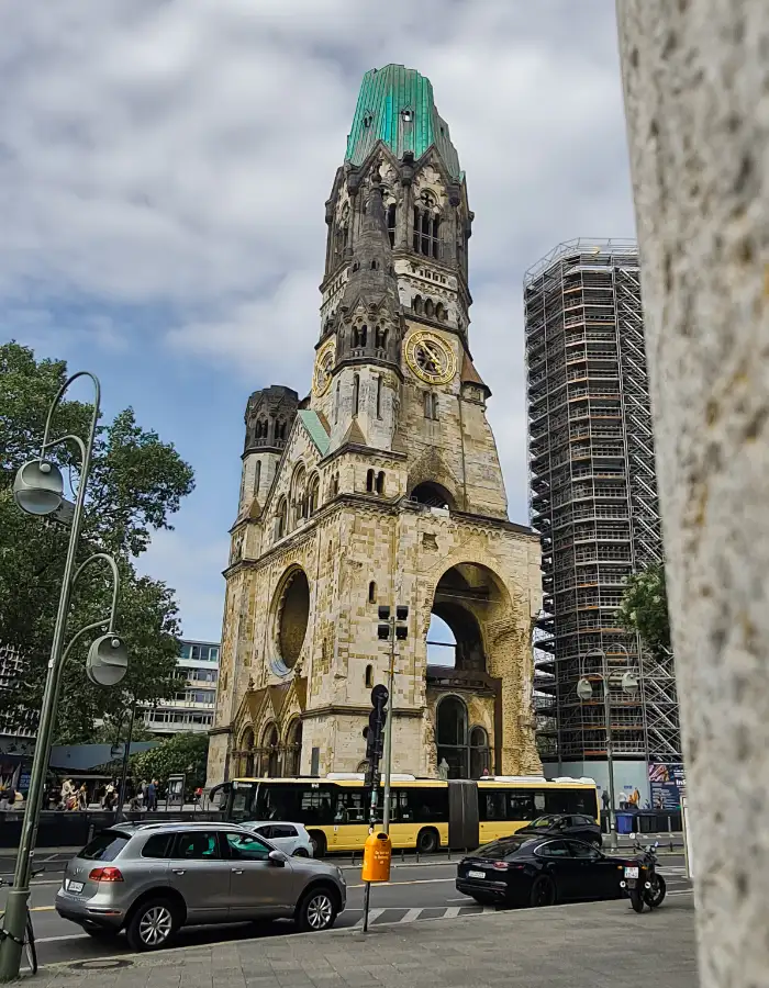 War-damaged spire of the Kaiser Wilhelm Memorial Church on Breitscheidplatz in Berlin with traffic passing