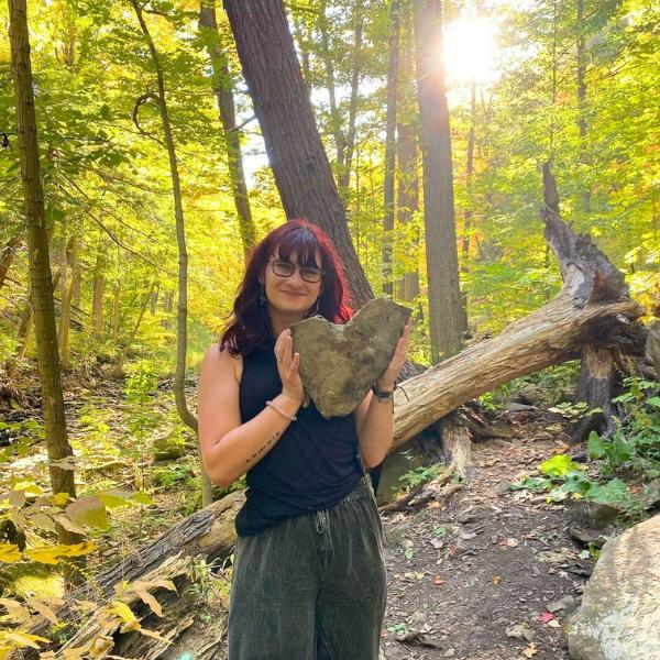 That's me, Lydia, with my favorite rock find. Lydia with heart rock