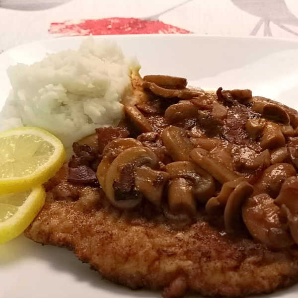 Oma's Jägerschnitzel with mushroom-bacon sauce. Breaded schnitzel, of course!