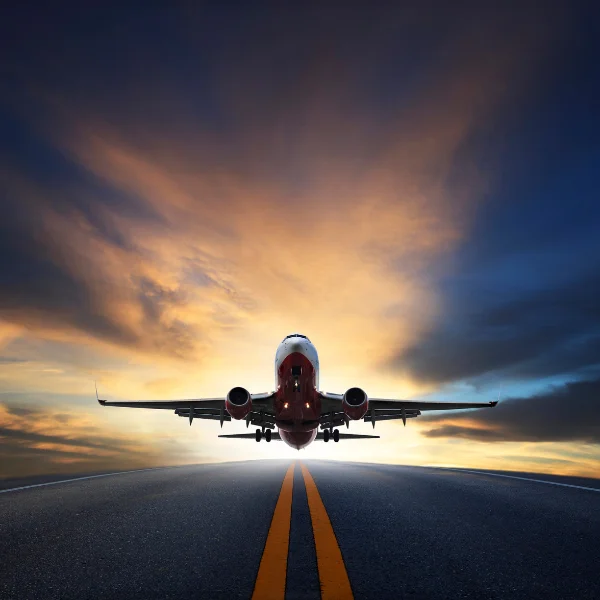 Plane taking off to new adventures. Plane taking off during sunrise under a dark sky.