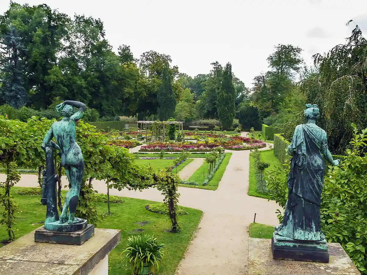 Bronze garden statues overlooking manicured beds in Sanssouci Park, Potsdam—top thing to do in Brandenburg Germany.