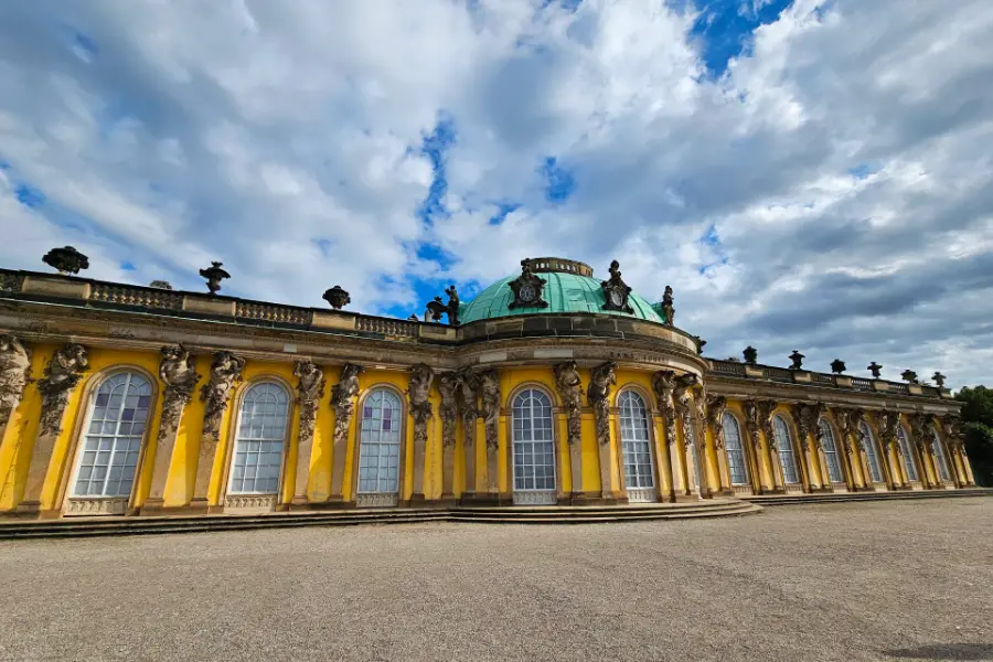 Yellow baroque facade and green dome of Sanssouci Palace in Potsdam near Berlin