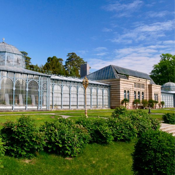 Greenhouses next to building behind a landscaped lawn at Wilhelma, Stuttgart