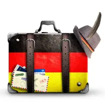 Vintage-style suitcase with the German flag design, a feathered hat, and travel stickers and stamps