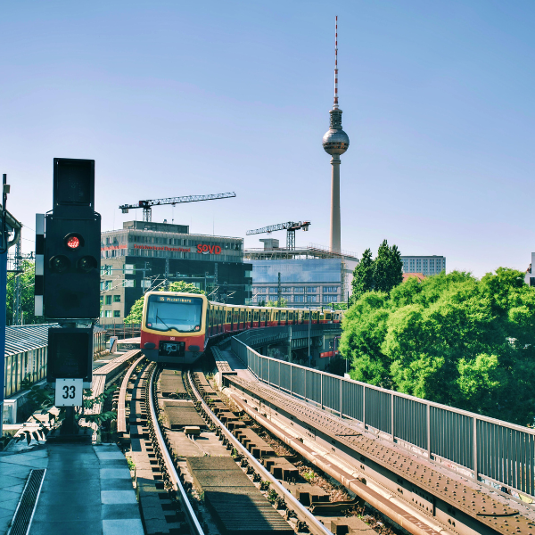 Train in Berlin by the TV Tower Train on tracks with buildings and trees