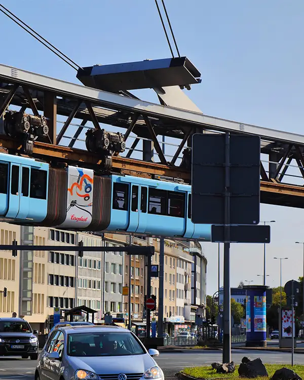 Wuppertal Schwebebahn Suspended Wuppertal Schwebebahn train passing over a busy street in Germany