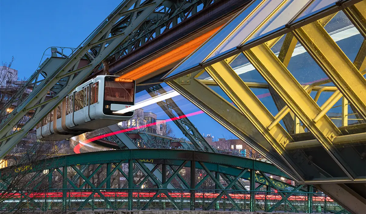 Wuppertal Schwebebahn Wuppertal Schwebebahn suspended monorail at night with station lights and motion blur