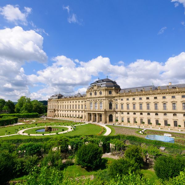 Würzburg Residence, Germany three-storey grey building fronted by landscape gardens in Würzburg Residence, Germany