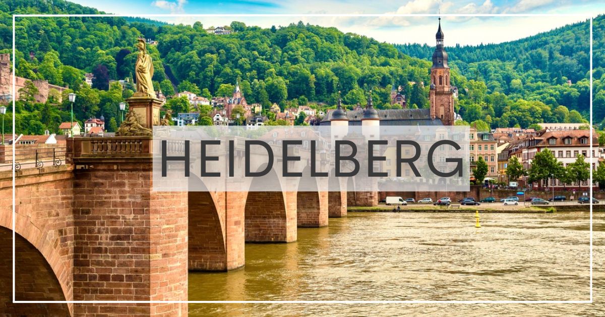 Sandstone bridge spanning the Elbe River with church and old buildings in Heidelberg, Germany