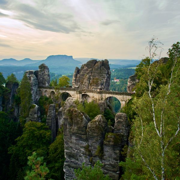 Stone bridge between sandstone rock towers, known as Bastei Bridge in Saxon Switzerland National Park, Germany.