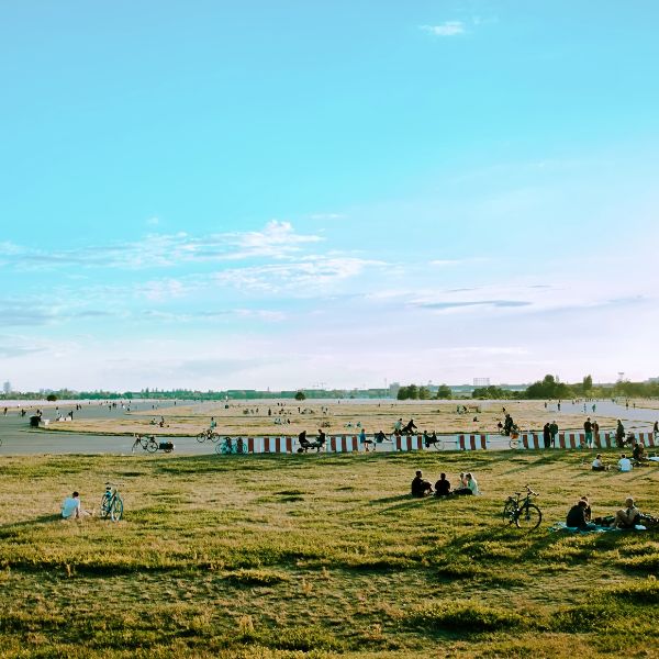 Airfield runway with people cycling and relaxing