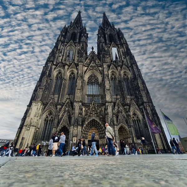Cologne Cathedral, Germany: grey cathedral with twin spires and people in front of it